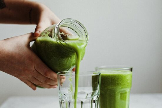 pouring Green Smoothie in a glass