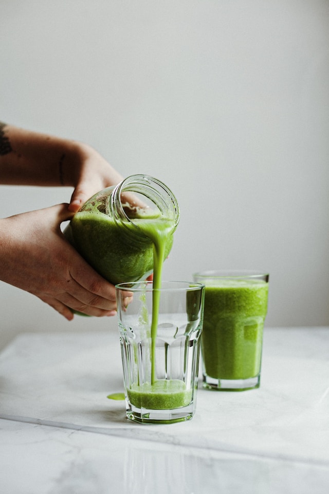 pouring Green Smoothie in a glass