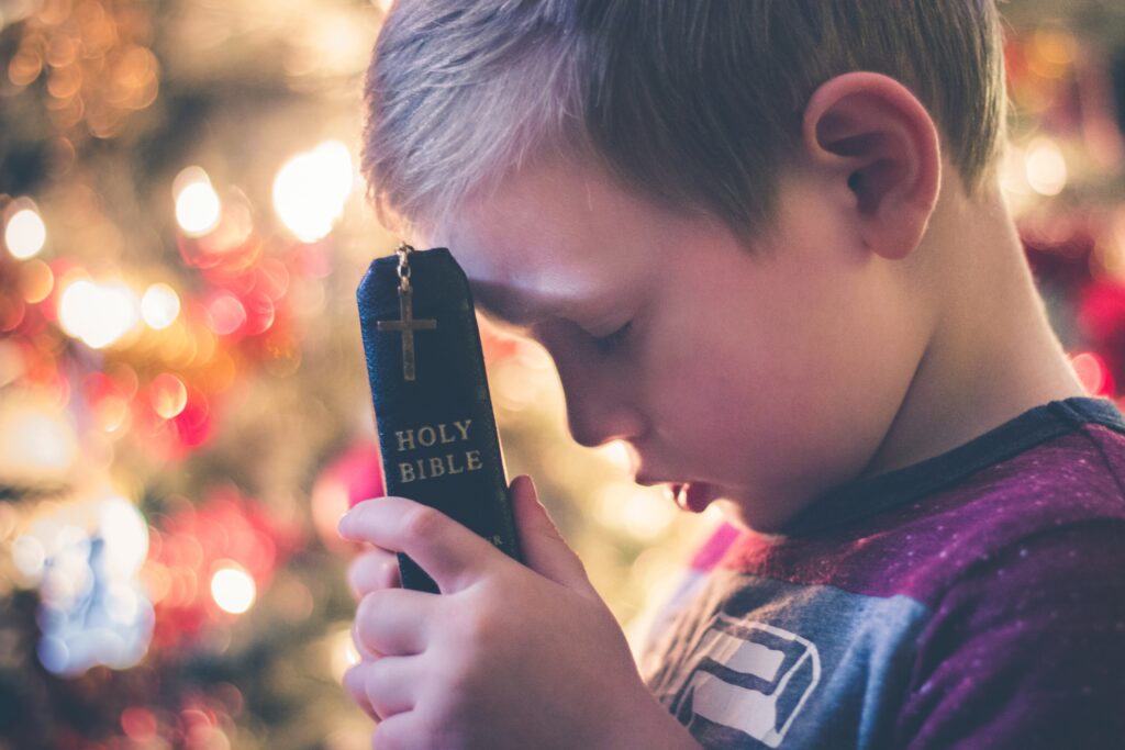 Boy holding Holy Bible-praying