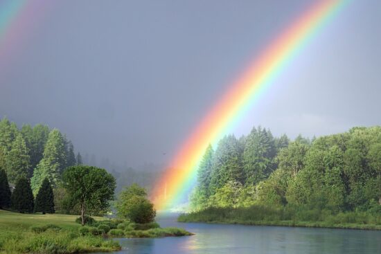 Resilience and faith- rainbow over peaceful river