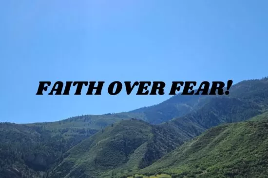 Faith Over Fear - Text over a background of green mountains and blue sky, showing hope, strength, trust in God, and overcoming fear