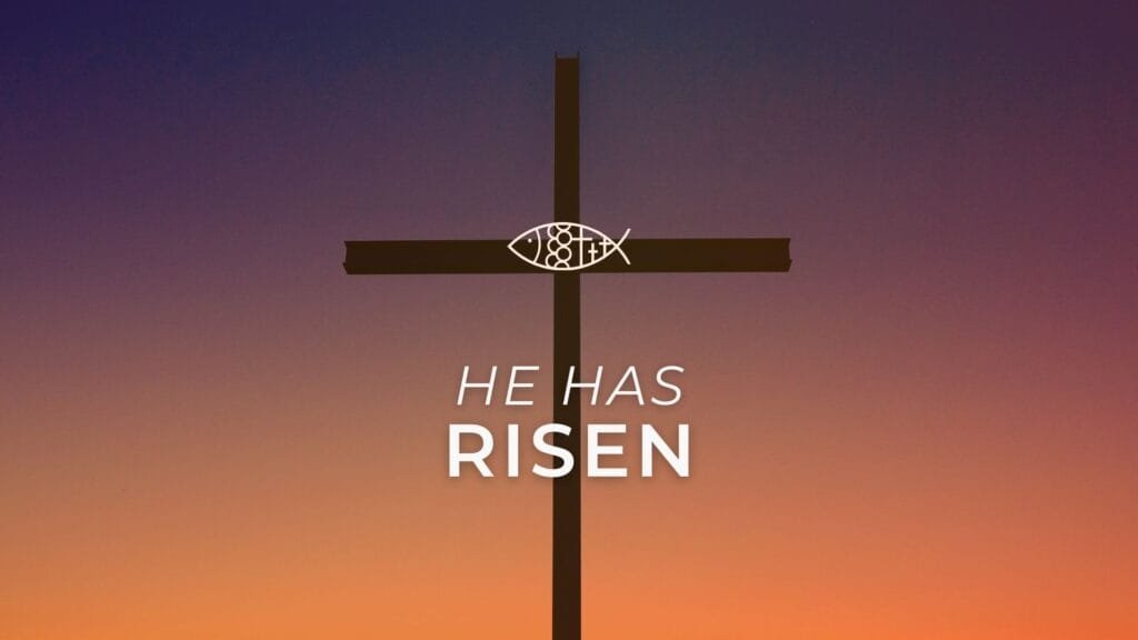 Cross at sunset with "He Has Risen" Resurrection