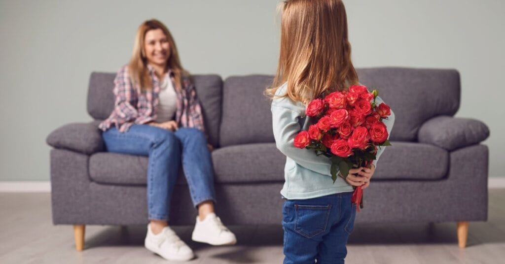 A young girl hiding roses for her mother reflects the thoughtful Mother's Day gifts on Amazon that bring joy and surprise.