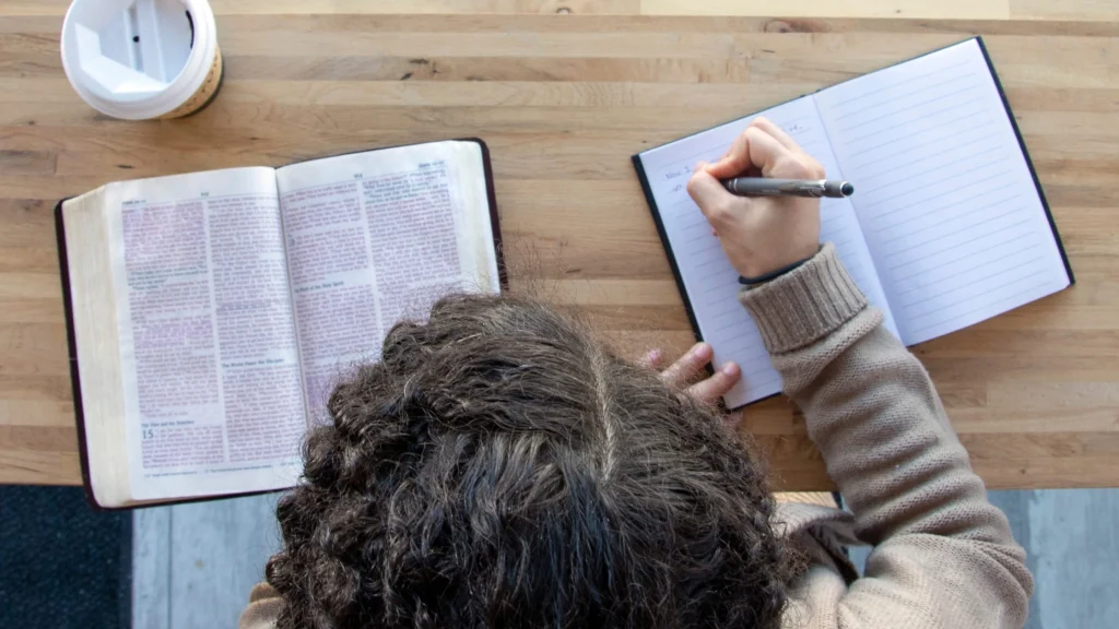 a boy writing his favourite bible verse