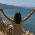 Woman worshiping by the sea, showing faith and trust when God seems silent.